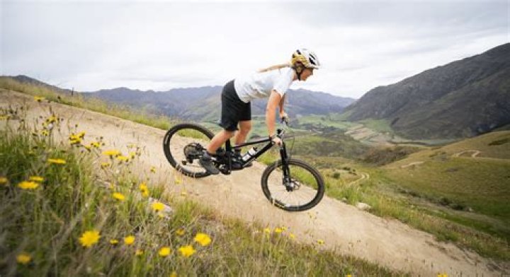 How can I walk downhill without hurting my knees?