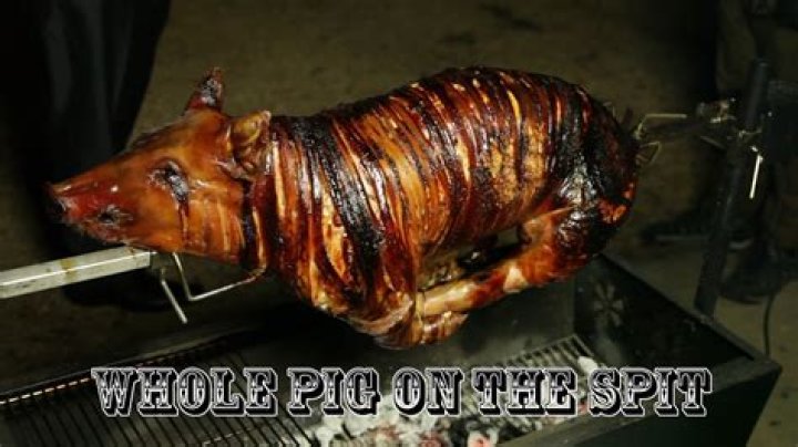 How do you cook a whole pig on a spit?