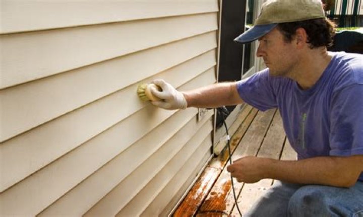 How do you remove dried stains from vinyl siding?