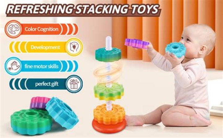 How does stacking toys help develop fine motor skills?
