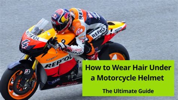 How should you wear your hair under a motorcycle helmet?