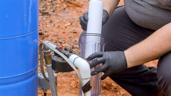 What are the two main problems with hard water in plumbing systems?