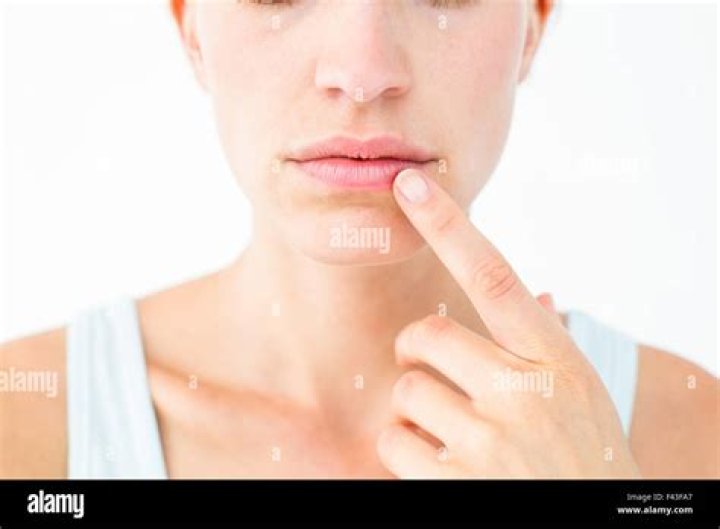 What does finger on lip mean?