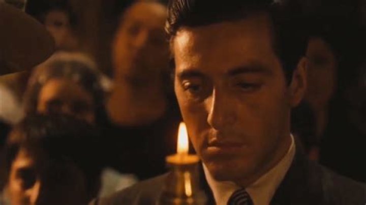 What is the role of a godfather at a baptism?