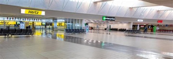 Where do you pick up rental cars at Phoenix airport?