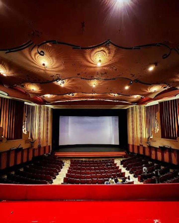Which theater in Mumbai still runs the film?