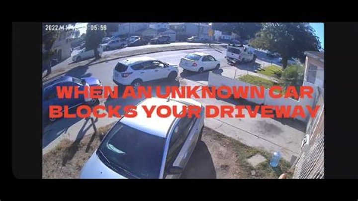 Who do I call to get a car towed that's blocking my driveway?