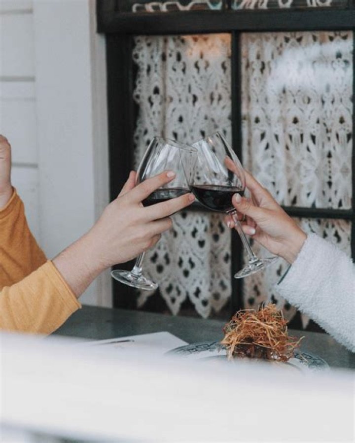 Why does red wine stain some people's lips?